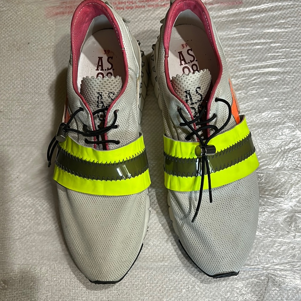 As98 tennis shoes. Greyish material with green and dark green band